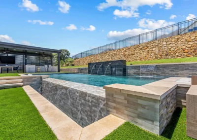 dallas pool builder - view of pool with water feature