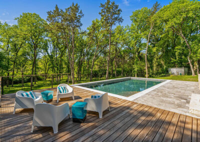 a pool with seating area in dallas