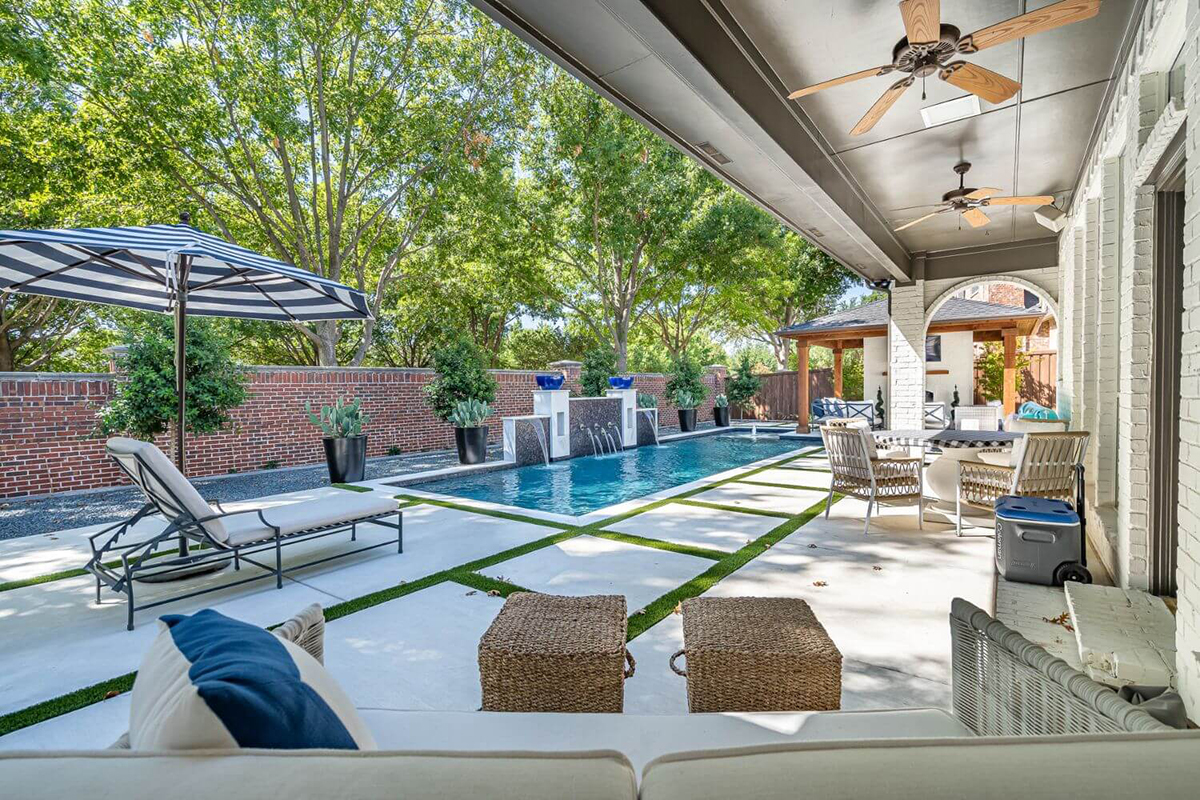pool and seating area behind a home in plano