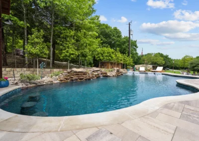 a pool with travertine decking